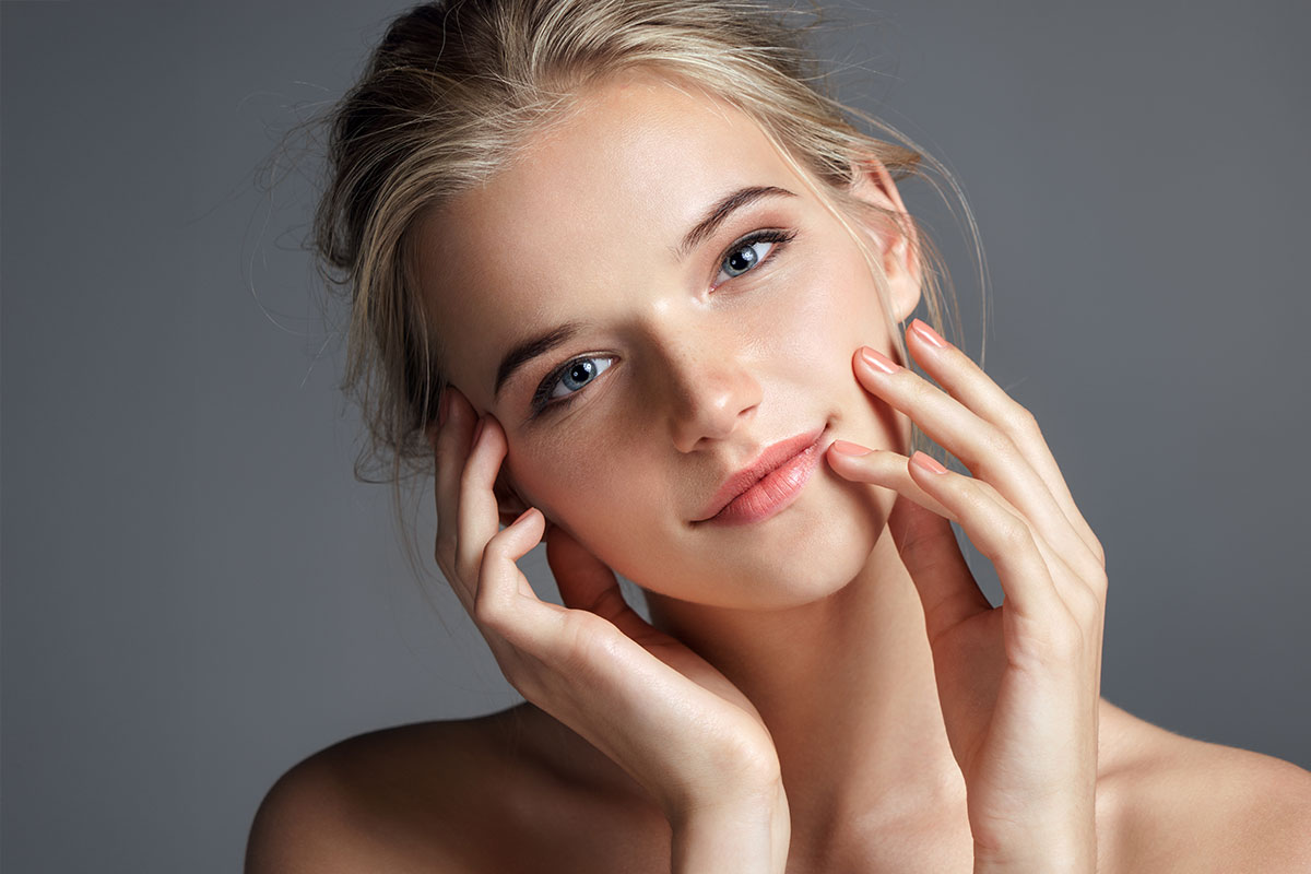 Blonde lady with her hands on her face